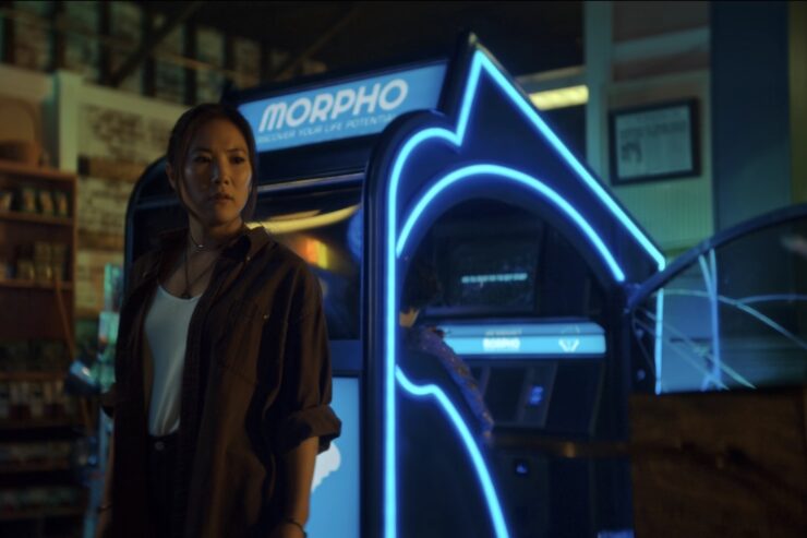 Ally Maki in The Big Door Prize, standing in front of morpho