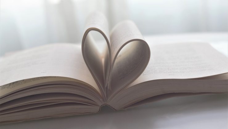 Open book with pages folded into a heart