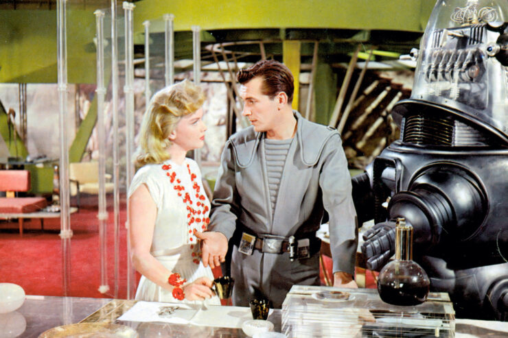 Scene from Forbidden Planet, featuring Anne Francis (as Altaira Morbius), Leslie Nielsen (as Cmmr. James J. Adams), and Robby the Robot