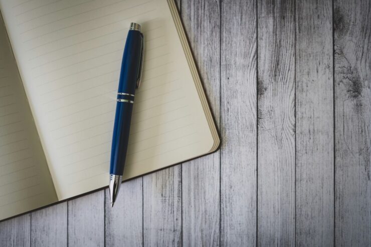 Photo of an open notebook and a fountain pen