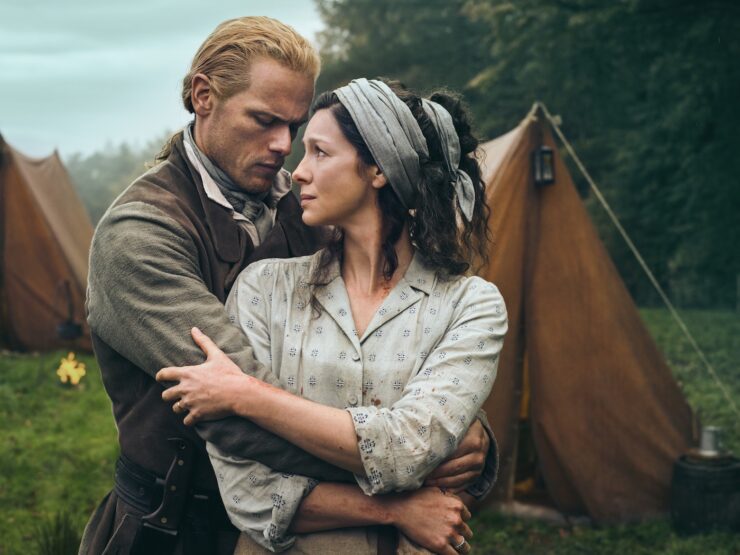 Still from Outlander, Season 7 Episode 1: A Life Well Lost, Jamie and Claire Fraser holding each other