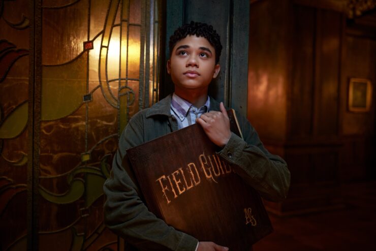 Boy holding The Spiderwick Chronicles book